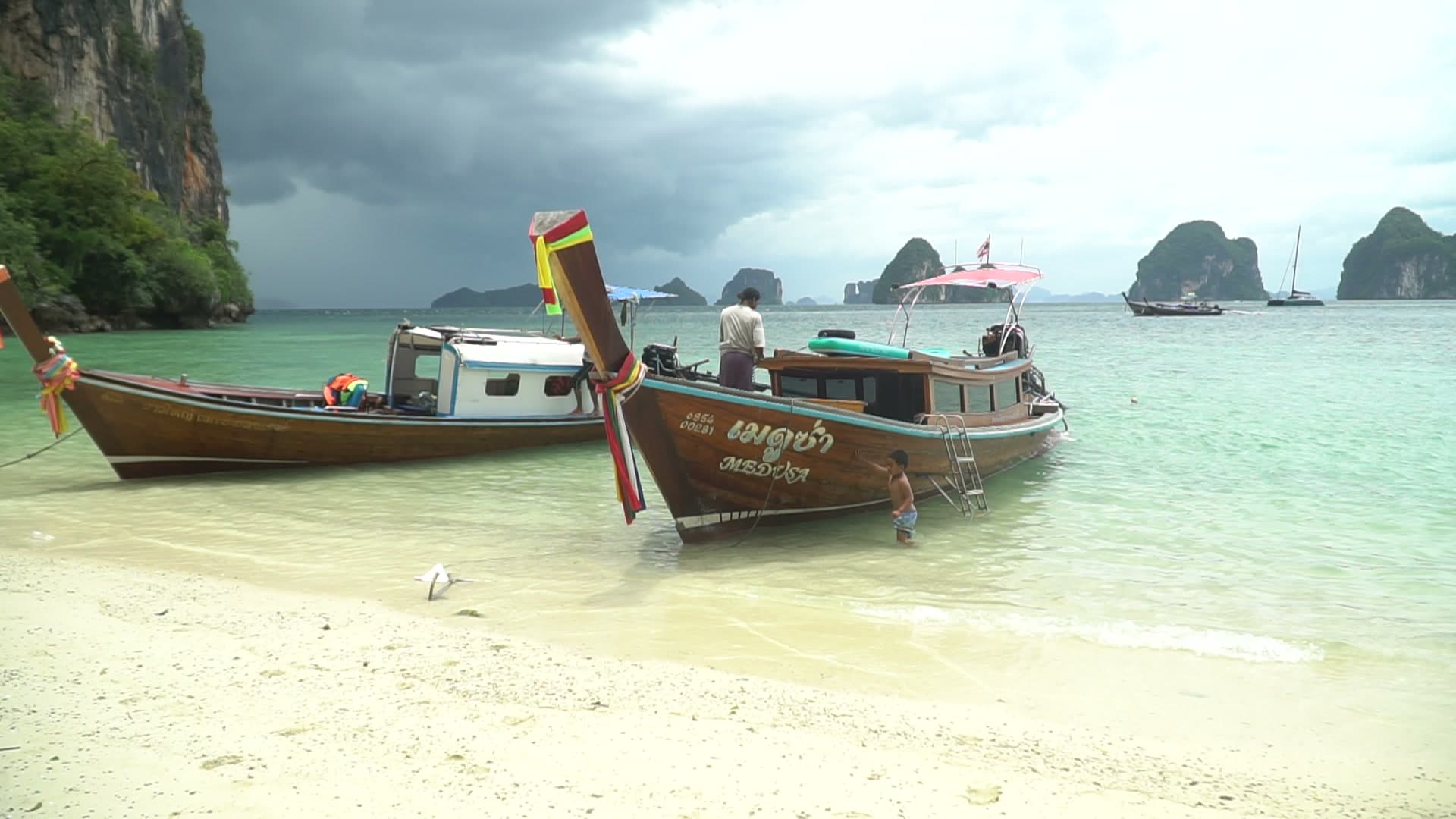 Longtail boat parked on a quiet beach during a private tour