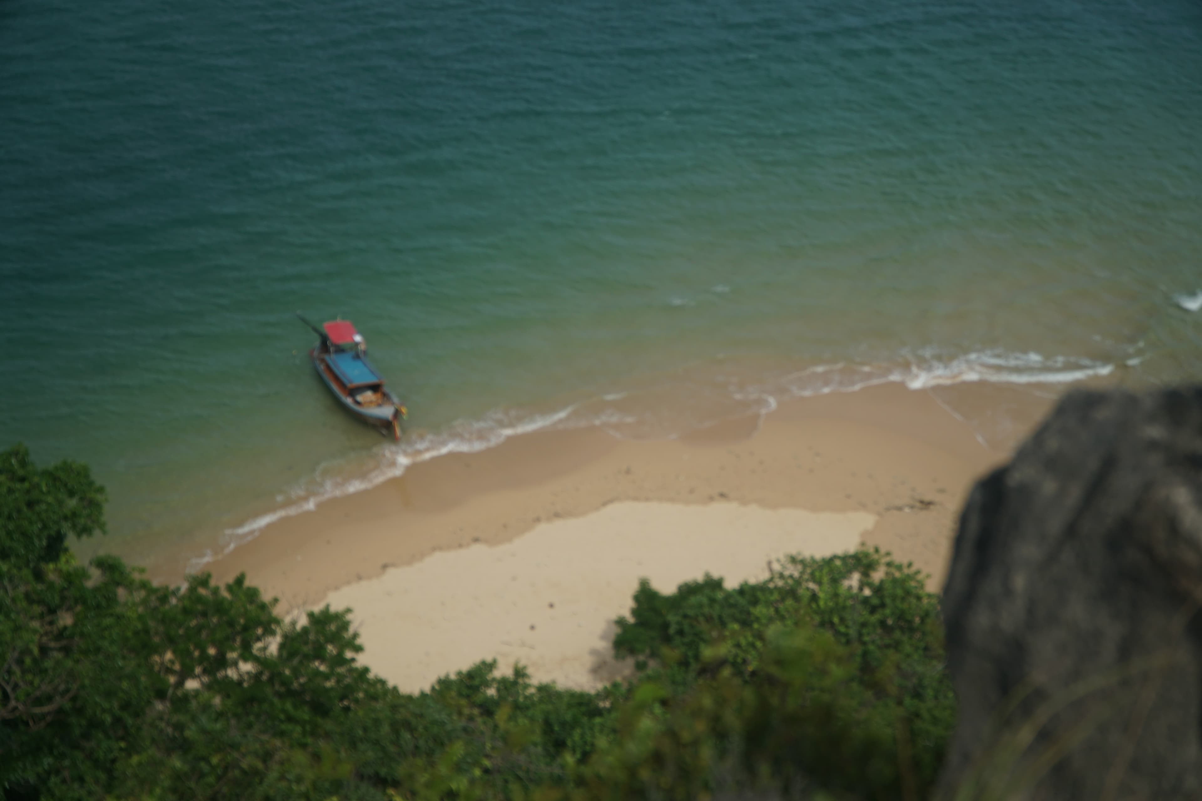 Quiet beach with a private boat near the shore