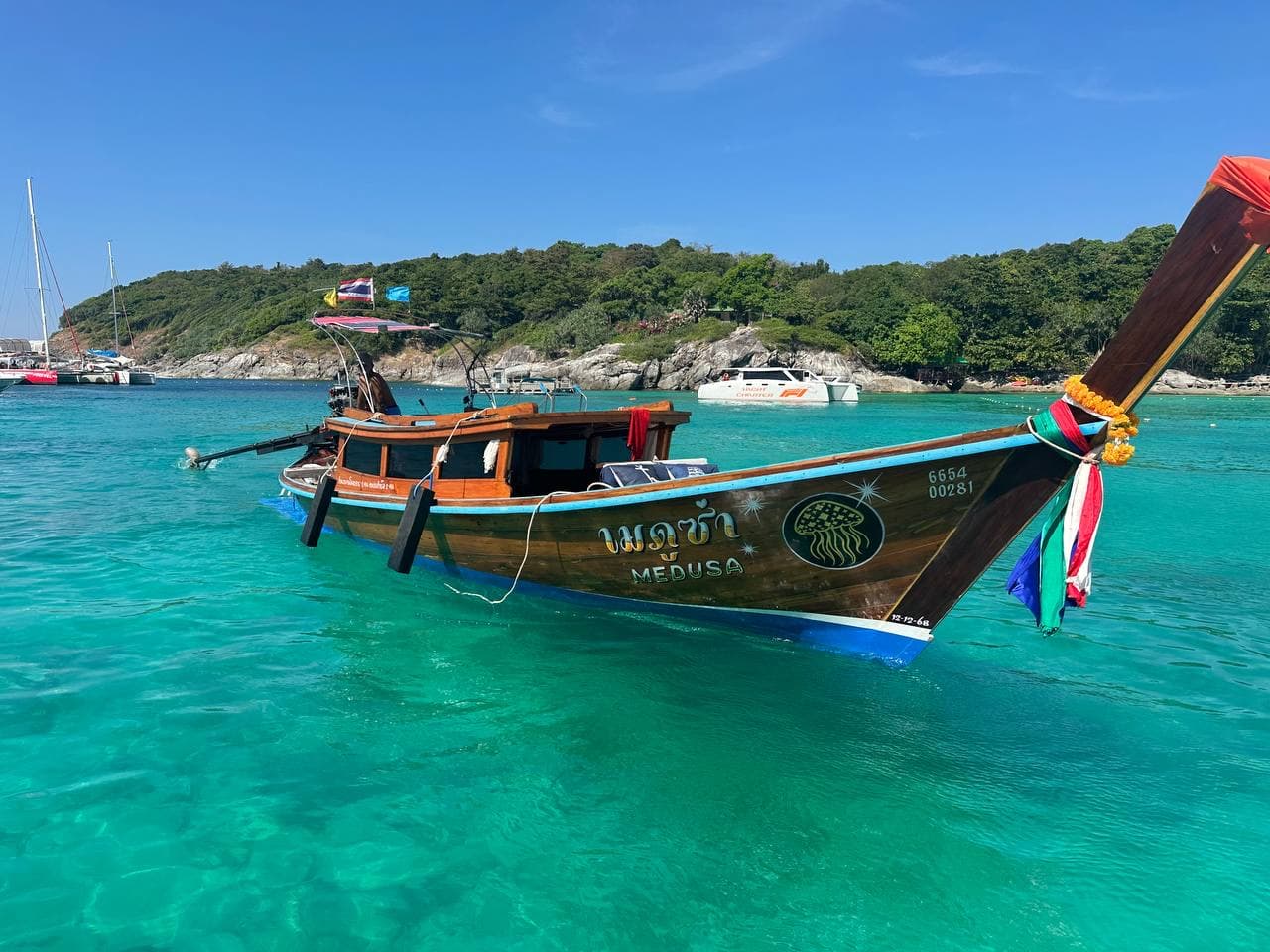 Private boat floating in turquoise water