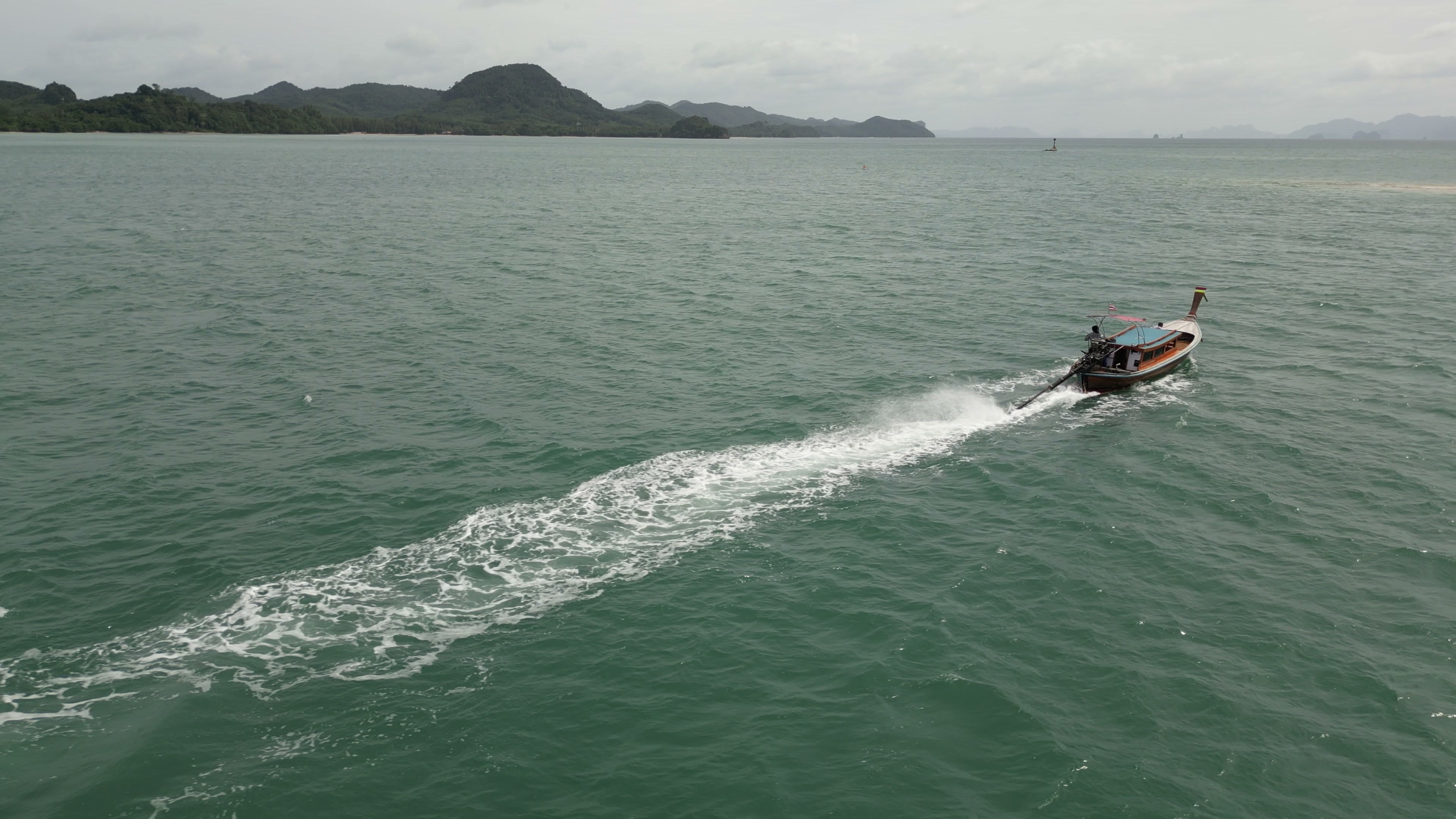 Private boat cruising through quiet island waters